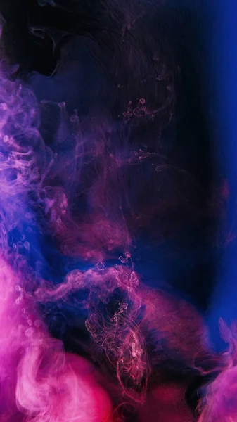 Paint water. Ink splash. Color smoke cloud. Fluorescent viva magenta pink blue purple vapor floating on dark black abstract background.