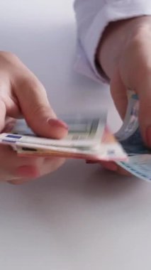 Dikey video. Nakit kredi. Para fonu. Finansal hesap. Ekonomi bütçesi. Avro kağıt banknotları kadın eli sayıyor..