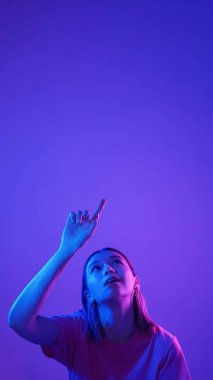 Sanal dokunuş. Yüksek teknoloji. Görünmez fütüristik düğmeye basan neon renkli ışık kızı mavi pembe boş arkaplanda izole edilmiş seçeneği seçer.