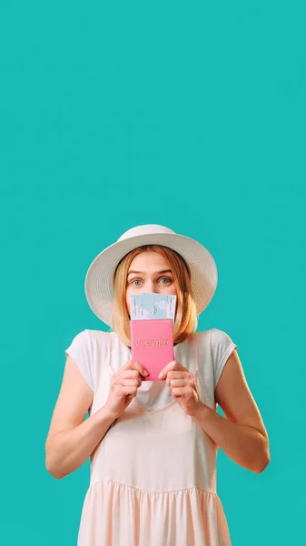 stock image Holiday trip. Summer journey. Passport control. Excited woman in white isolated holding documents and tickets on turquoise copy space background.