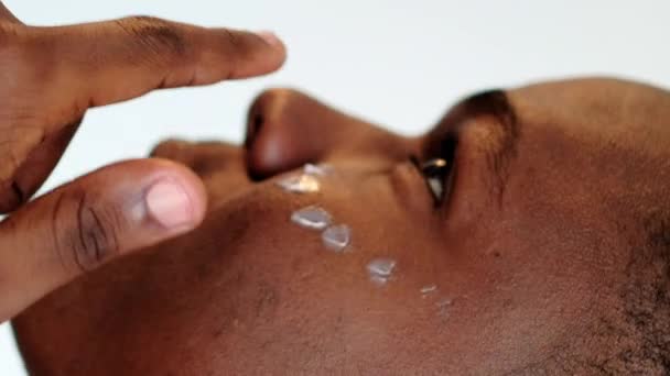 垂直录像 皮肤保湿 面部护理 防皱护肤 有信心的男人在眼底涂抹面霜化妆品的特写 — 图库视频影像