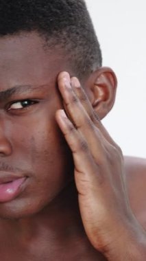 Dikey video. Sabah baş ağrısı. Cilt stresi. Basınç endişesi. Tatminsiz bir adamın yüz masajına ve acıdan muzdarip tapınaklara yaklaşması..