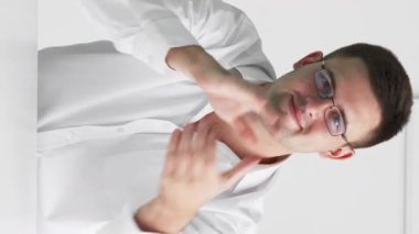 Dikey video. Bravo alkış. Destekleyici adam. Sanal toplantı. Akıllı adam masa başında oturmuş el çırpıyor. Işık odasındaki meslektaşlarını teşvik ediyor..