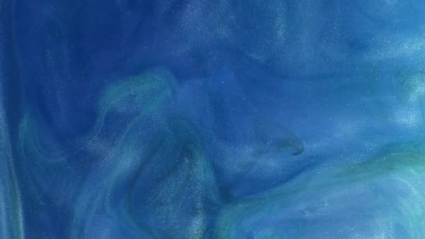 光る液体だ インクの水 粒子の質感 渦巻きを描く 青い色輝く輝く煙雲の動きアブストラクトアート背景 — ストック動画