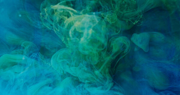 Ink water splash. Color smoke cloud. Paint mix. Defocused blue green mist texture spreading abstract art background with free space.