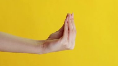 Dikey video. Ev yapımı ürün reklamı. Temizlik oyunu. Çoraplar taklit gösteriyor. Kol koruyucu eldivenlerle kavga eden kadın sarı arka planda zafer işareti var..