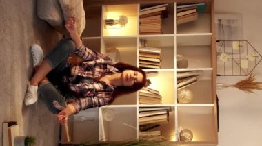 Dikey video. İlham verici bir meditasyon. Sakin bir kadın. Evde rahatla. Sakin, orta yaşlı bir kadın. Lompoz veriyor..