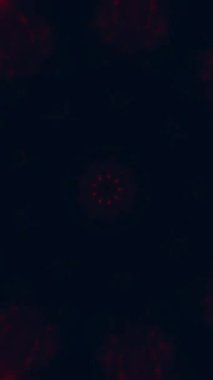 Dikey video. Ateş mandala. Kaleydoskop hareketi. Bulanık kırmızı turuncu parıltı, koyu mavi soyut arka planda çiçek simetrik süslemesini kıvılcımlar..