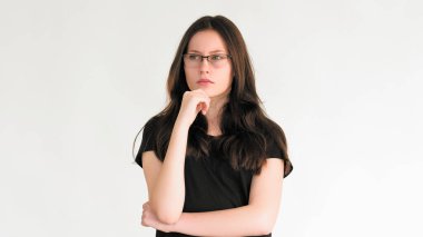 Dalgın bir yüz. Dert tefekkür. Kafası karışmış, kafası karışmış, gözlüklü zeki kadın beyaz boş bir alanda izole edilmiş olduğunu düşünüyor..