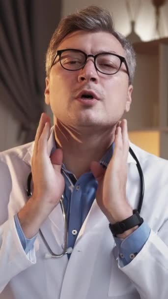 垂直录像 医疗检查 医生指示 诊所博客 聪明的男人解释说 在现代室内环境中 通过触摸耳朵下的咽喉区域来获取Vlog的自我检查技术 — 图库视频影像