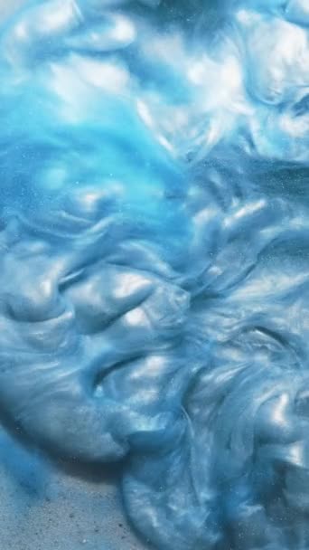 垂直录像 闪闪发光的油漆飞溅 墨水水 爆炸的云彩蓝色光泽液体在纹理表面扩散运动抽象艺术背景 — 图库视频影像