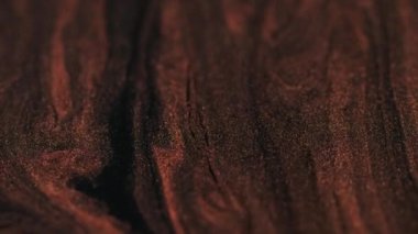 Parlak mürekkep. Boya akışı sıvısı. Odaklanamayan kırmızı parıltılı parlak altın rengi desen parçacıkları hareket parçacıkları soyut arkaplan.