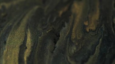 Parlak parlak boya. Mürekkep arkaplanı. Altın rengi parıldayan sıvı akrilik parıldayan siyah karışım hareketli soyut doku..