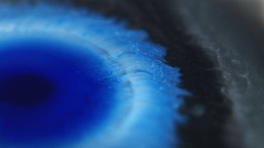 Boya lekesi. Mürekkep damlası. Odaklanmamış mavi siyah renk ıslak leke ışıl ışıl parçacıklar desen sıvı dökülme soyut sanat arka planı.