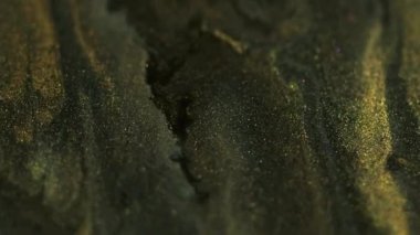 Parıltılı jel boya. Mürekkep arkaplanı. Parlak yeşil siyah sıvı akışkan akrilik altın parıltılı karışık hareket hipnotik mistik soyut doku.