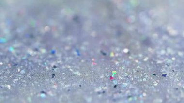 Sıvı sim dökülmüş. Parlak jel dokusu. Odaklanmamış holografik payet parçacıkları şeffaf ıslak parlatıcı sıvı akışı soyut sanat arkaplanı ve bokeh ışıkları.