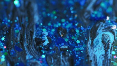 Akrilik boya karışımı. Islak sim dökülmüş. Odaklanmamış mavi renk ışıltılı pullu parçacıklar su sıvı parlatıcı emülsiyon mürekkebi soyut sanat arkaplanı.