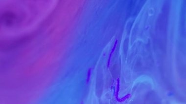 Mürekkep suyu. Fantezi boyası. Parlak bir sıvı. Odaklanmamış mavi pembe renk pürüzsüz parlak dumanlı yağ emülsiyonu parlak parçacıklar jel akış hareketi soyut sanat arka planı.
