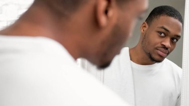 Sabah rutini. Yüz bakımı. Hijyen sağlığı. Taze yüzlü yakışıklı adam. Kirli sakallı beyaz havlu. Aynaya bakıyor..