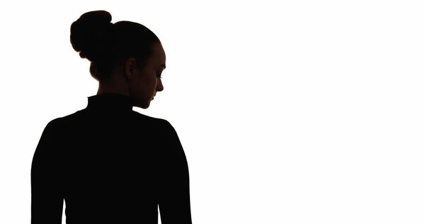 Upset silhouette. Loneliness melancholy. Dark contrast back view outline of sad depressed woman isolated on white copy space background.