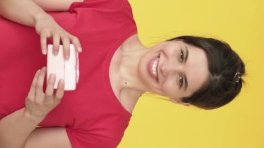 Dikey video. Kötü bir hediye. Heyecanlı kadın hayal kırıklığına uğradı. Boks hediyesini açmaktan sıkıldı. Üzücü duygularını sarı renkte ifade ediyor..