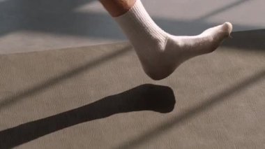 Atletik yaşam tarzı. Aerobik egzersizi. Spor sahasında çıplak ayakla yürüyen aktif insanlar yıldız pilates sınıfı antrenmanından önce kadın fitness koçuyla kapalı spor salonunda..