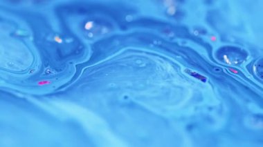 Emülsiyon karışımı. Parlak sıvı damlası. Odaklanmamış mavi renkli ışıldayan parçacıklar kabarcıklar su boyası sıvı mürekkep harmanlama hareketi soyut sanat arkaplanı.