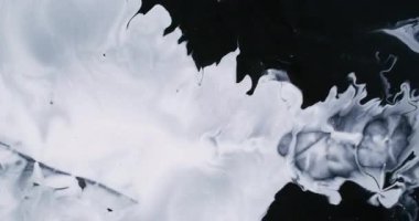 Beyaz leke. Boya genişlemesi. Geniş emaye akıntısı koyu siyah, düz olmayan yüzey üzerinde karmaşık bir şekilde yayılır. Sanat sıvısı soyut arkaplanı aydınlatır.