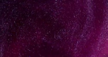 Mürekkep sarmalı. Pırıltılı sis. Odaklanmamış pembe renk sıvı parlak partikül doku dairesi su soyut sanat arka planında harmanlanıyor.