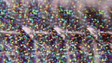 Konfeti örtüsü. Bulanık fantezi titreşimi. Renkli kırmızı, sarı, ışıl ışıl parçacıklar, arkaplanda Bokeh efektiyle parlayan mercek..