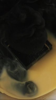 Dikey video. Boya sisi. Mürekkep suyu. Siyah sıvı dökülme karışımı beyaz akış obsidian doku geometrik daire çerçeve kübü soyut arkaplan.