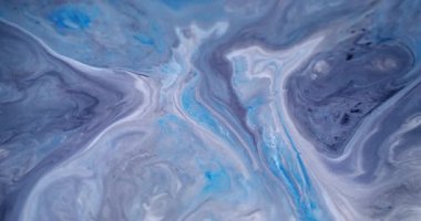 Enamel sıçradı. Akış parçacıkları. Çözünmüş mavi beyaz renk dalgalanması mürekkep akrilik doku parçacıkları soyut arkaplanda yayılıyor.