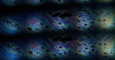 Kaleydoskop etkisi. Benzin yüzeyi. Renkli bulanık resim boyası sıvı siyah sıvı üzerinde akıyor. Mercek hareketini klonla soyut arkaplan.