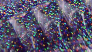 Bulanık pullar. Harika bir üçgen. Sarı turuncu çok renkli noktalar ışıldayan parçacıklar Bokeh ışığı soyut arka planında hareket ediyor.