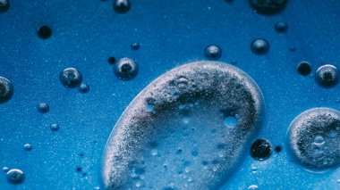 Yağ sanatı. Boya karışımı. Odaklanmamış mavi mürekkepli su kabarcıkları sıvı esansı yuvarlar sıvı soyut yaratıcı arka planda yüzer.