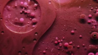 Yağ damlası. Jel köpükleri. Soyut sanat eserlerinin arka planına dökülen su sıvısındaki pembemsi pembe boya yuvarlak deseni..