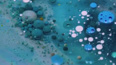 Emülsiyonu bırak. Boya jeli. Yağ kabarcıkları. Turkuaz pigment topları saydam bulanık sanat sıvısı mermer mavi su soyut arka plan derinliğinde yüzüyor.