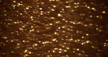 Bulanık parıltı. Bokeh ışığı. Soyut ışıklandırılmış arkaplanda altın sarısı renkli mercek ışıltılı ışıltılı ışıltılı desen.