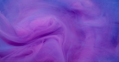 Dönen boya sıçraması. Fış sanatı. Suyun içindeki sıvı mürekkep dokusu soyut arkaplana yayılıyor..