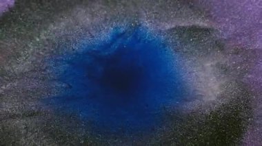 Mürekkep sıçraması. Parıltı akıyor. Soyut sanat arka planına yayılan su sıvısı nemli dokuda çözünmüş koyu mavi renkte parıldayan karışık boya..