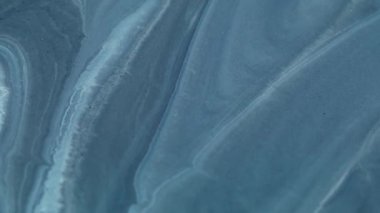 Karışım akışı. Dalgalı mürekkep. Odaklanmamış mavi renkli mermer doku ıslak lekeler su parçacıkları soyut sanat arka planına dökülüyor.