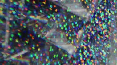 Bulanık pullar. Harika bir üçgen. Sarı turuncu çok renkli noktalar ışıldayan parçacıklar Bokeh ışığı soyut arka planında hareket ediyor.