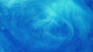 Mürekkep sıçraması. Renkli su. Bulanık mavi cyan parlak parçacıklar kimyasal emaye, ıslak akrilik doku emülsiyonu sanatın soyutlamasına yayılıyor..