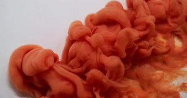 Renkli su. Boya akışı. Bulanık turuncu bronz girdap kimyasal akrilik emülsiyon duman pigmenti soyut beyaz sanat arka planına yayılıyor.