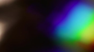 Gökkuşağı parıltısı. Bulanık yanardöner parlama. Odaklanmamış mavi, kırmızı, kıvılcım saçan ışık desenli lens soyut, koyu, siyah arka planda yanıp sönüyor..