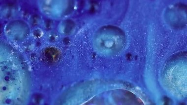 Parıldayan mürekkep. Sihirli mavi karışım. Renkli akış sıvısı parıldayan yağ boya dokusu soyut bulanık bokeh ışık sanat arka planında hareket ediyor.
