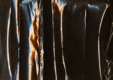 Katlanmış kaplama. Eski film dokusu. Mavi turuncu renkli ışık parıltısı toz çizikleri yıpranmış folyo sesi koyu siyah sanat soyut arka plan.