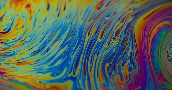 Kimyasal sıvı. Damlacıklar akar. Odaklanmamış sarı mor renkli mürekkep sıvısı. Soyut arkaplanda yüzen bronz mavi pembe..