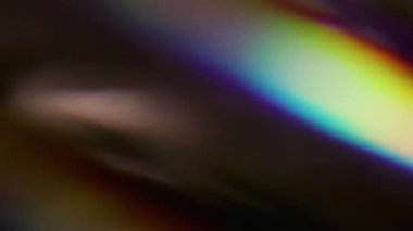 Bulanık, parlak. Gökkuşağı arka planı. Odaklanmamış mavi yeşil renkli ışık spektrumu soyut optik sanat üzerinde parıldıyor..