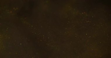 Hipnoz sıvısı. Sanat pırıltısı. Parıldayan karışım parçacıkları bokeh kıvılcımlarında harmanlıyor. Renkli altın metalik boya akışı soyut odaklanmış siyah arkaplan.